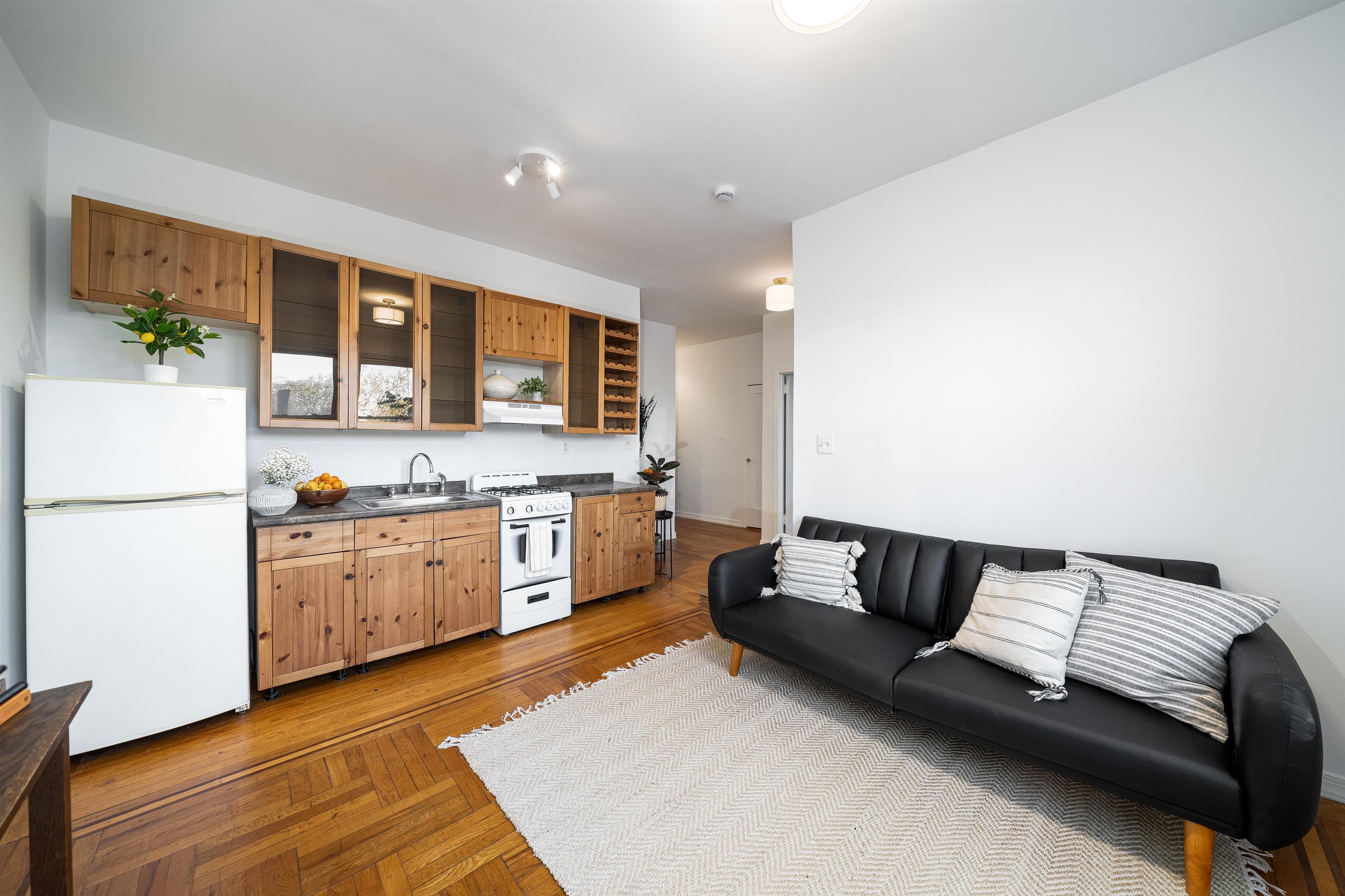 a living room with furniture and kitchen view