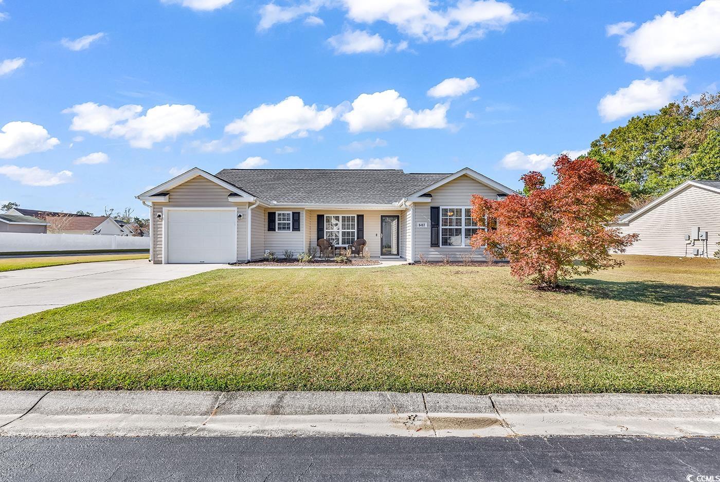 Ranch-style home with a front lawn and a garage