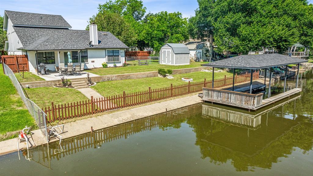 a view of a house with pool and chairs