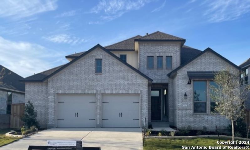 a front view of a house with garage