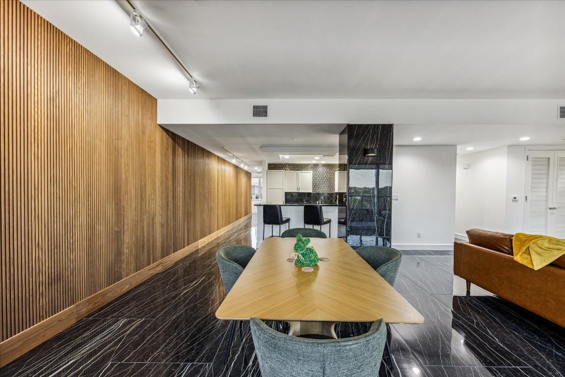 a living room with dining room and wooden floor