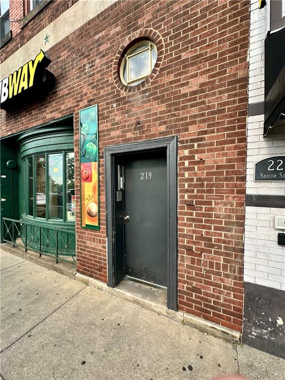 a brick building with a door and a window