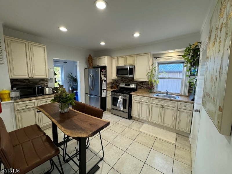 a kitchen with a refrigerator and a stove top oven