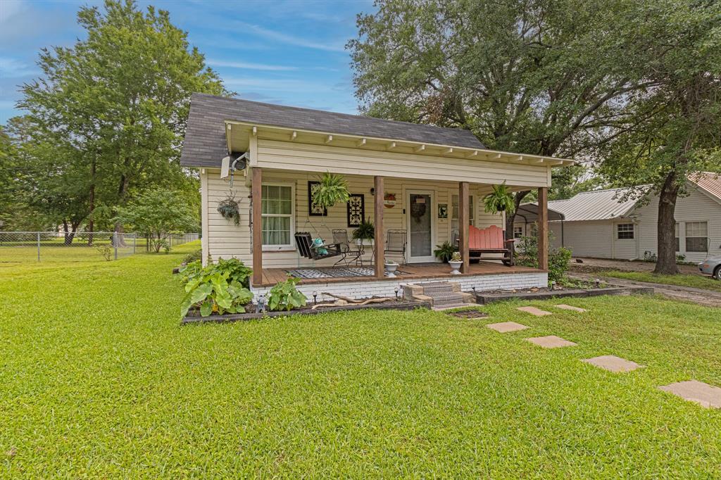 a view of a house with swimming pool and a yard