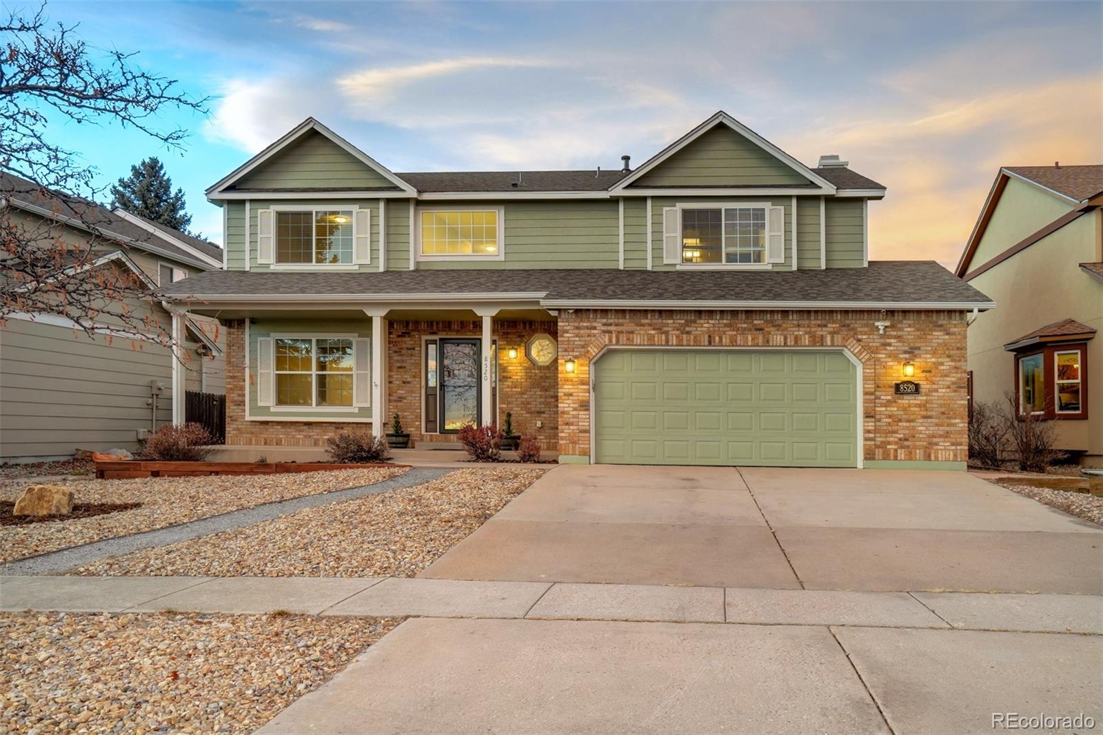 a front view of a house with a yard and garage