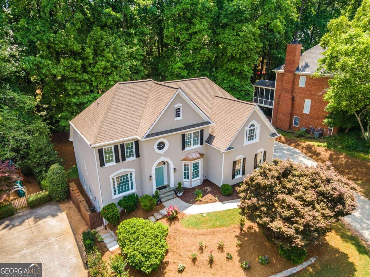 an aerial view of a house with a yard