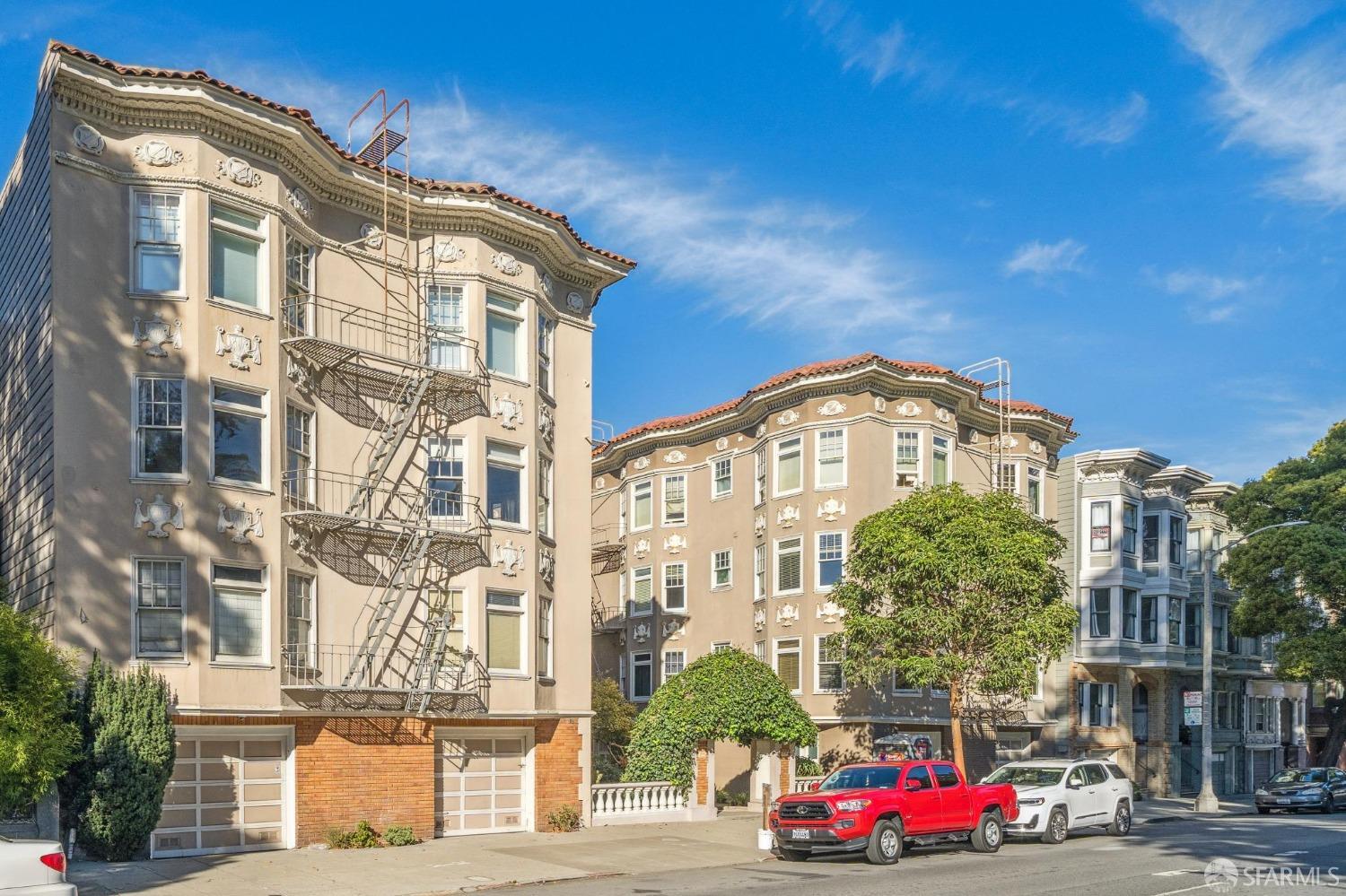 a front view of a multi story residential apartment building with yard