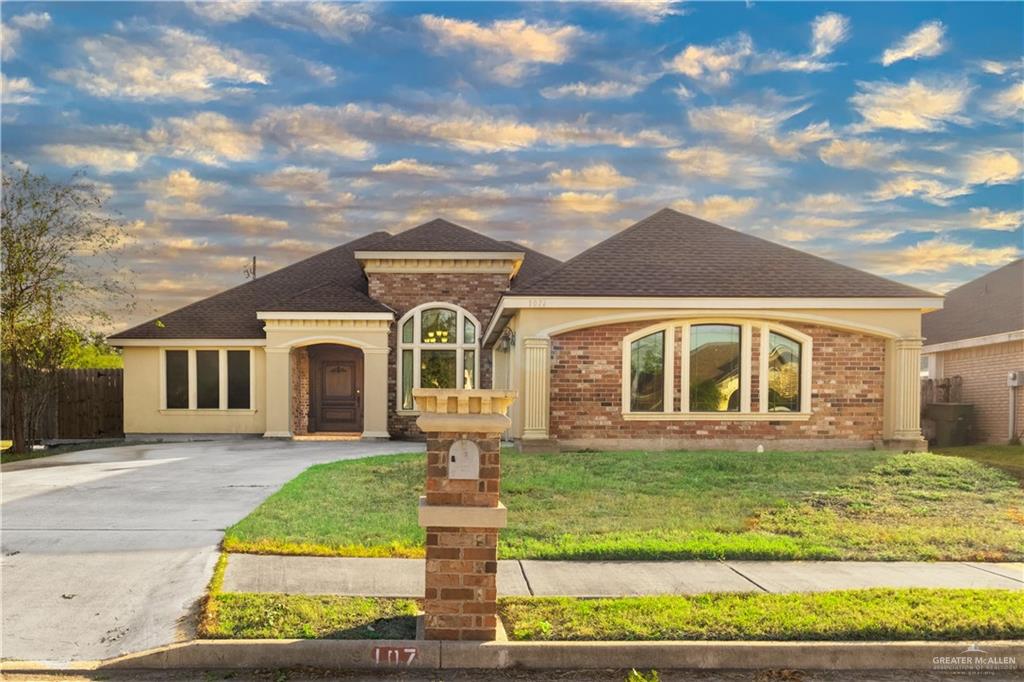 a front view of a house with a yard