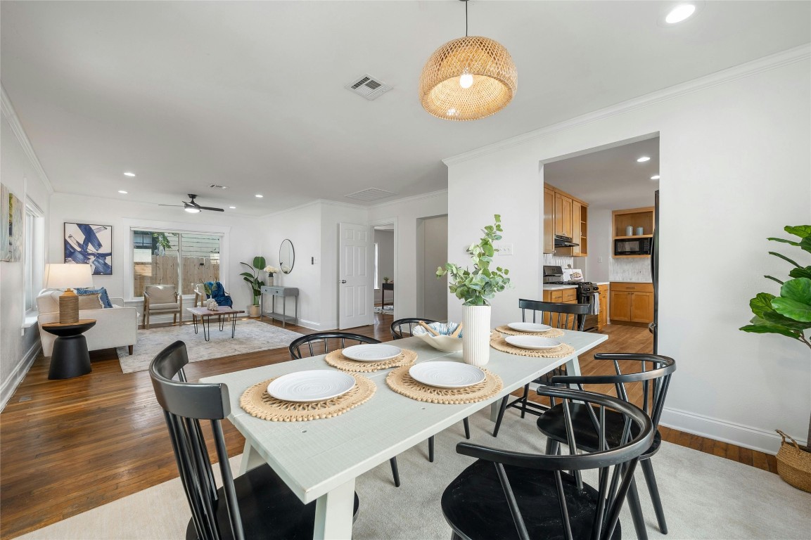 a view of a dining room with furniture and wooden floor