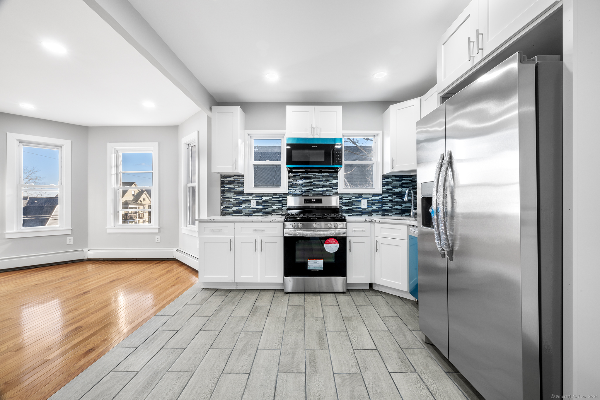 a kitchen with a refrigerator and a stove top oven