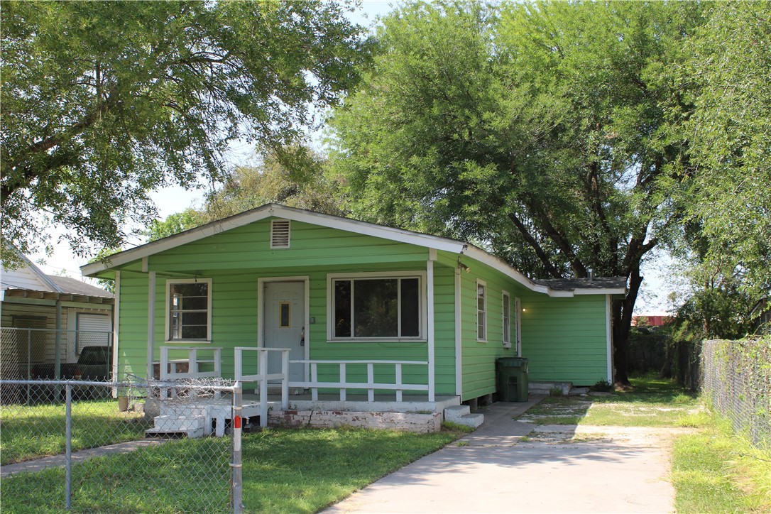 a front view of a house with garden and patio