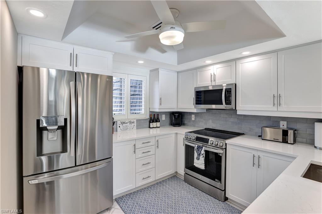 a kitchen with stainless steel appliances and refrigerator