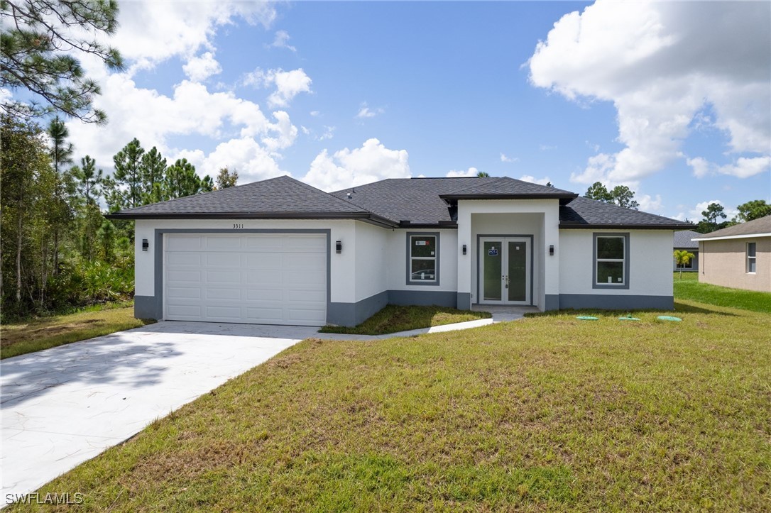 a front view of a house with a yard and garage