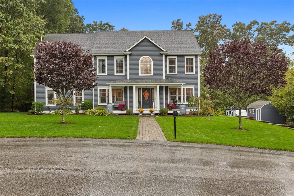 front view of a house next to a yard