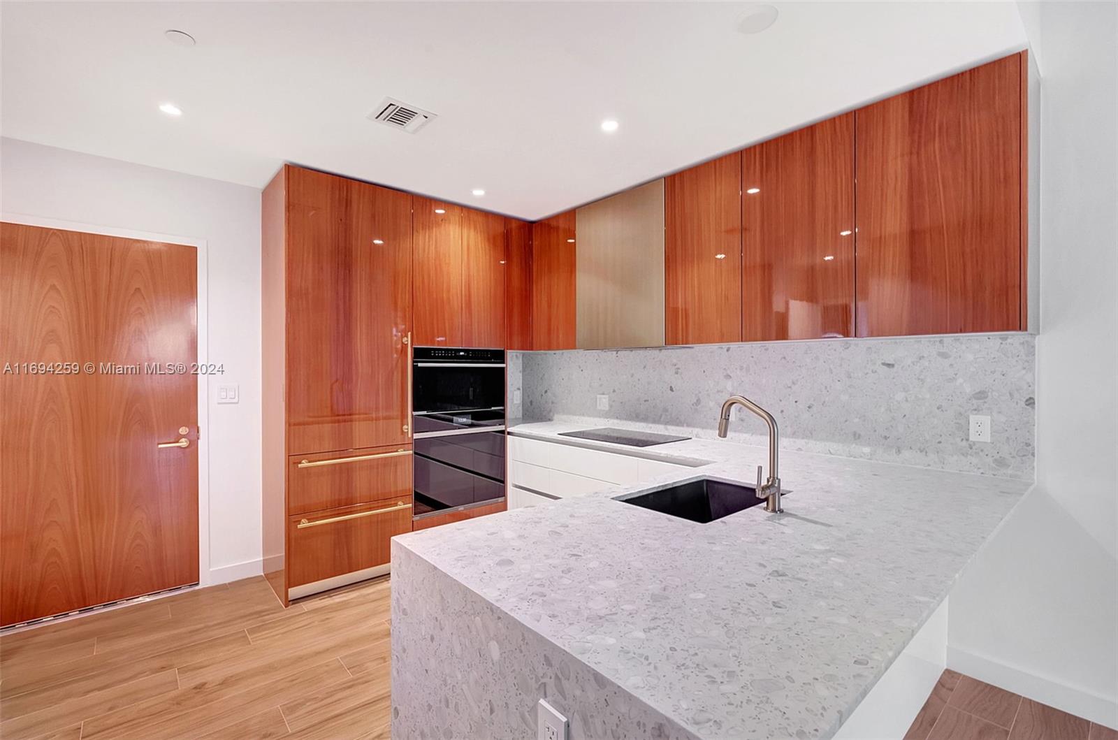 a kitchen with a sink cabinets and appliances