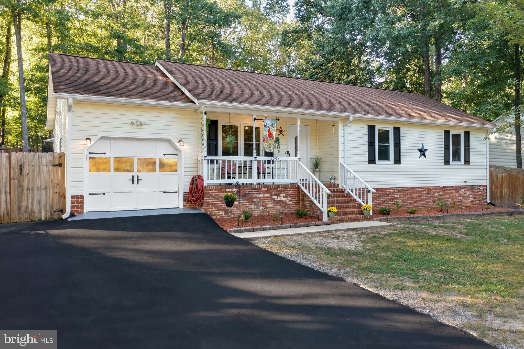 a view of house with backyard and ceiling fan