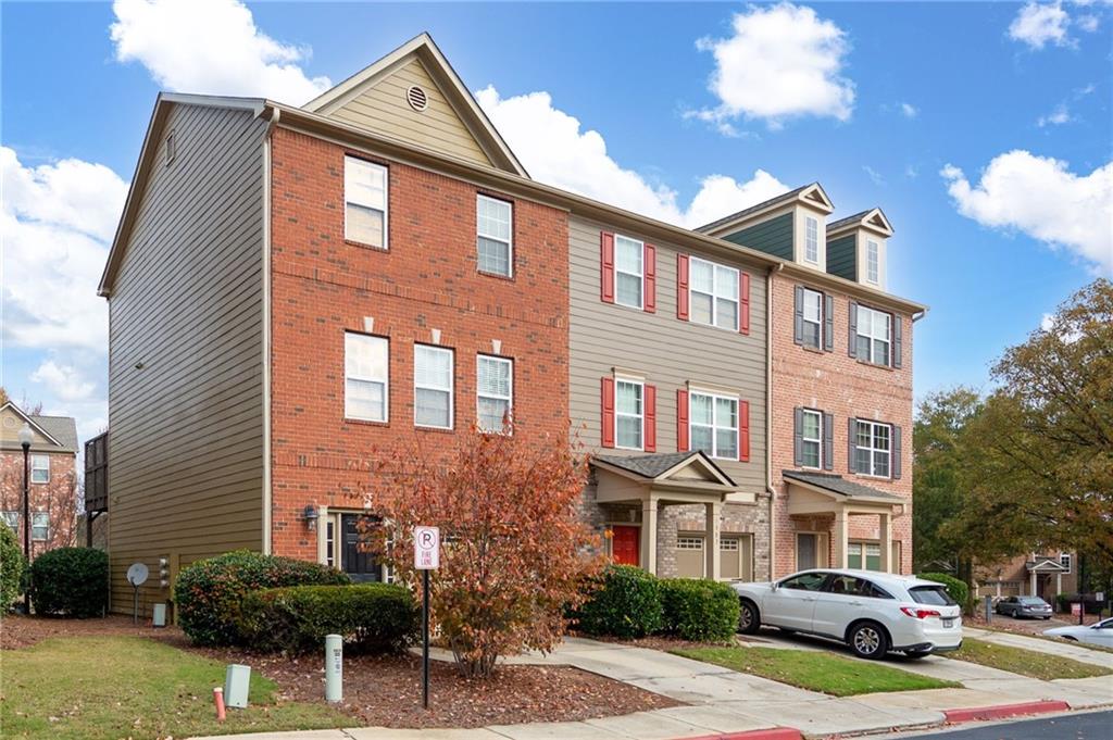 a front view of a residential apartment building with a yard