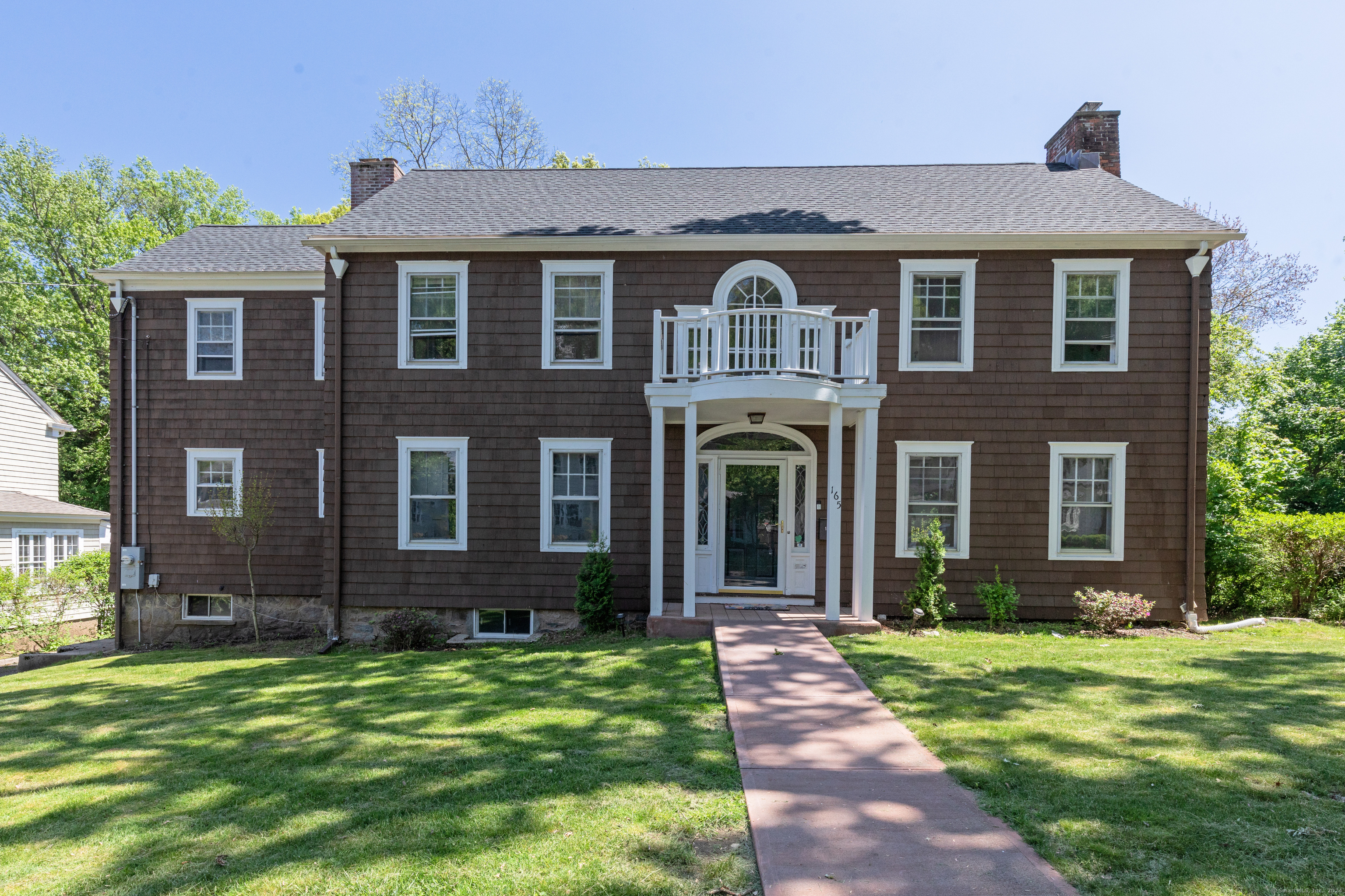 a front view of a house with garden