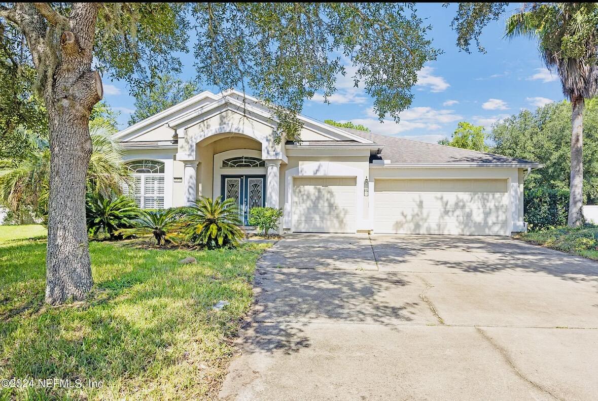 a front view of a house with a garden