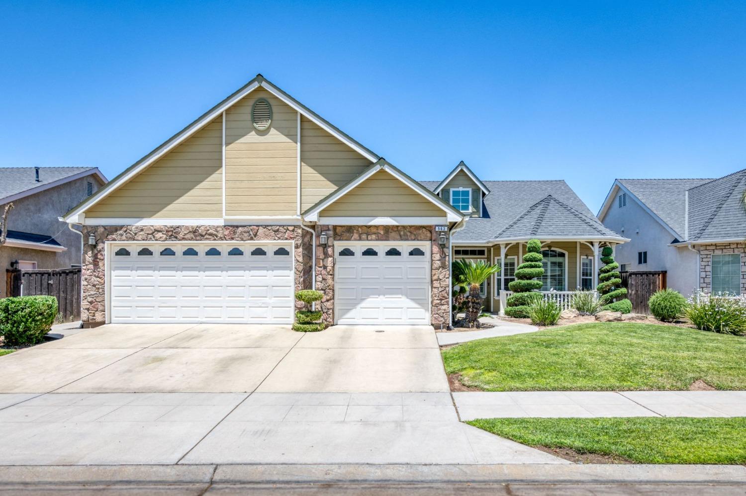 a front view of a house with a yard and garage