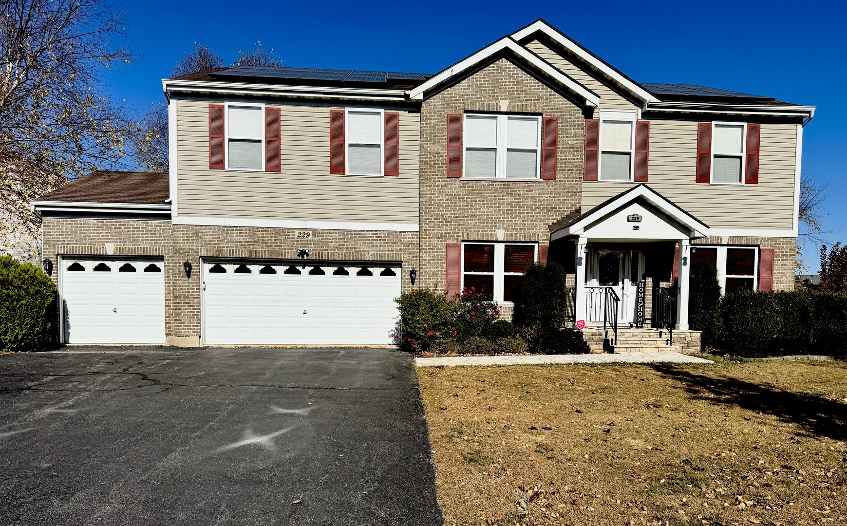 a front view of a house with a yard