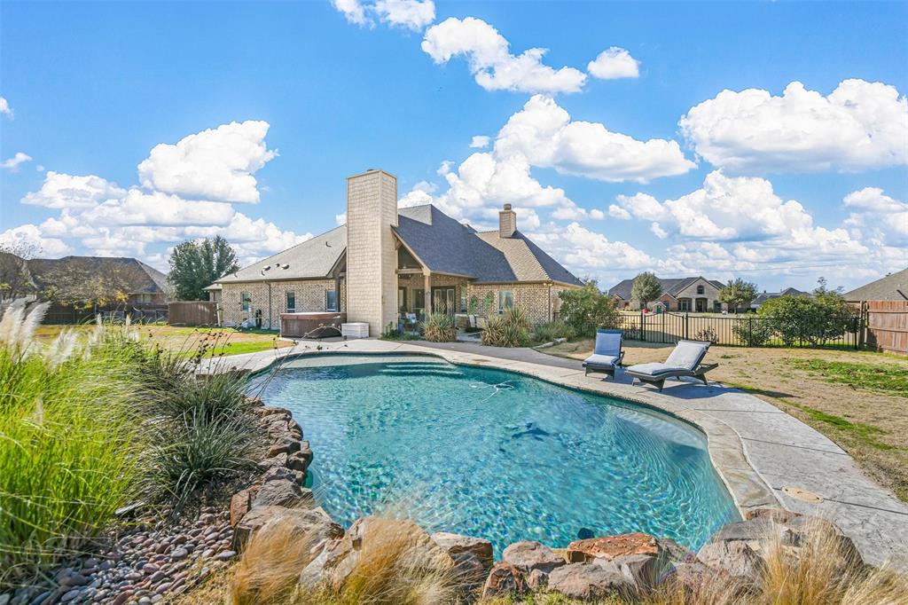 a view of a house with swimming pool and sitting area