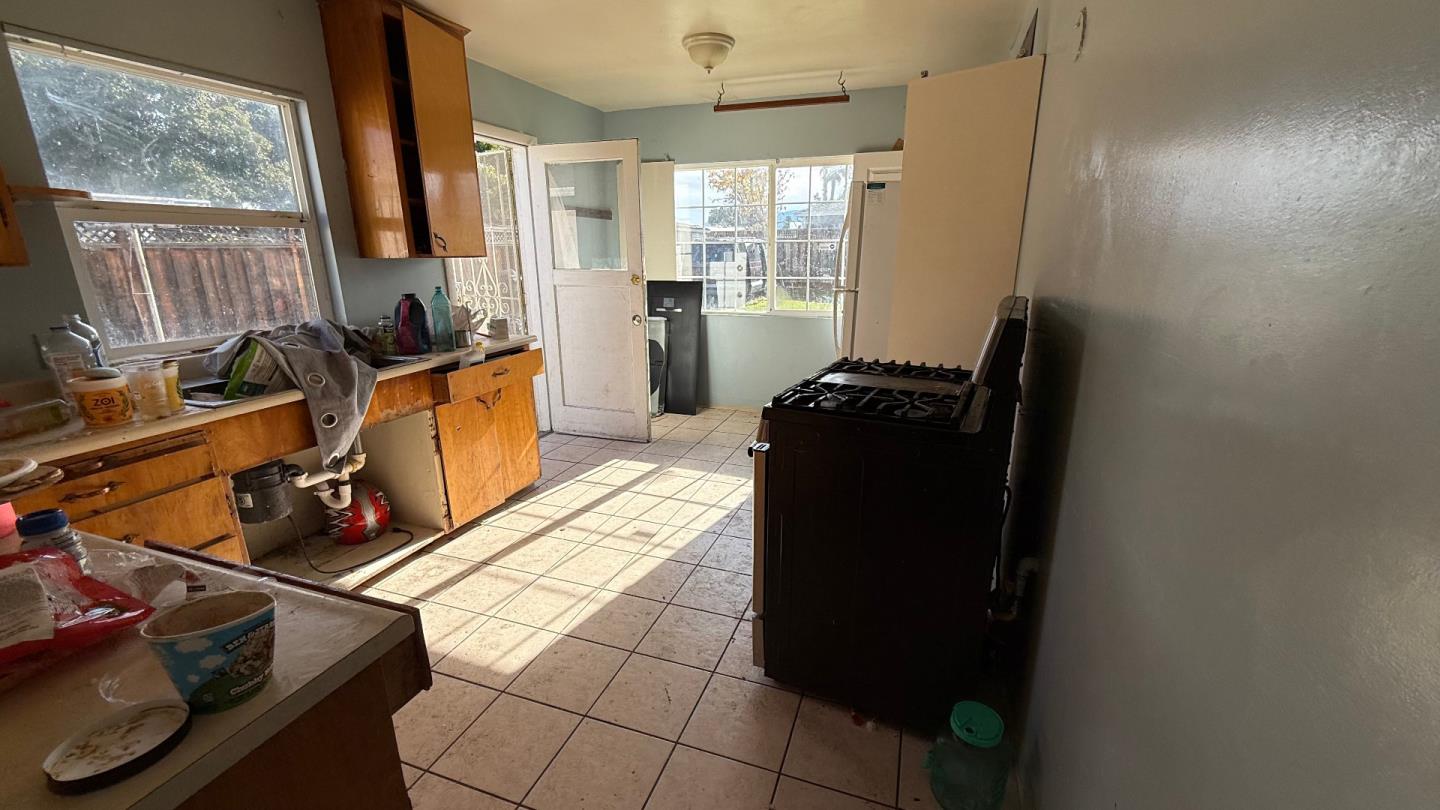 a kitchen with a refrigerator and a stove