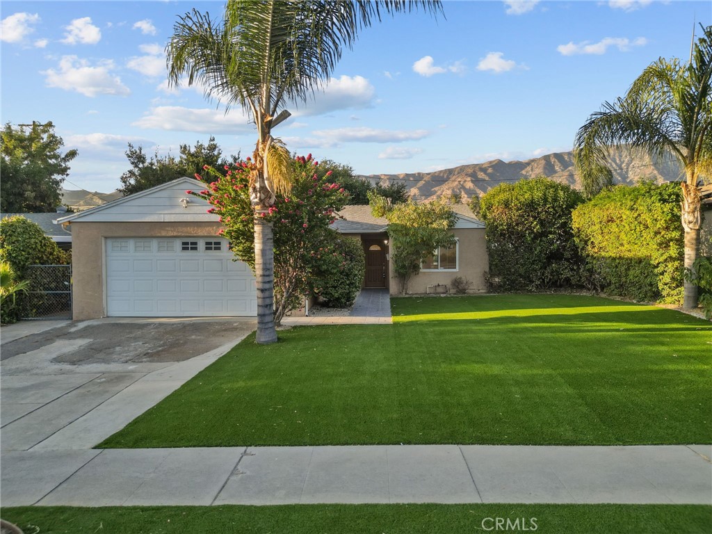 a front view of house with yard and green space