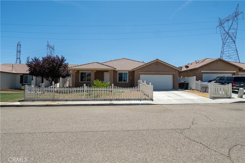 front view of a house with a yard and a palm tree