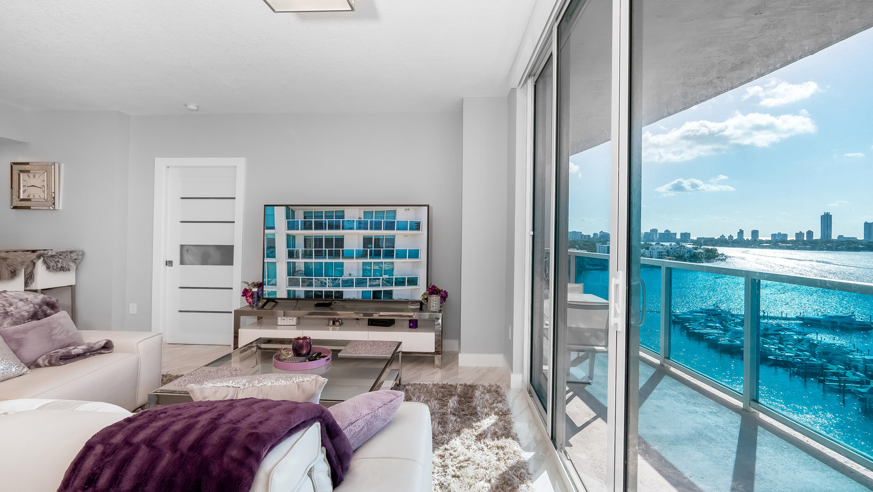 a bedroom with furniture and a large window