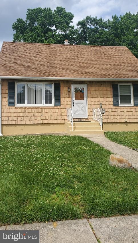 a front view of house with yard and outdoor seating