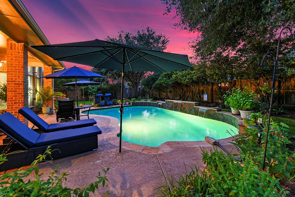 an outdoor space with pool and furniture