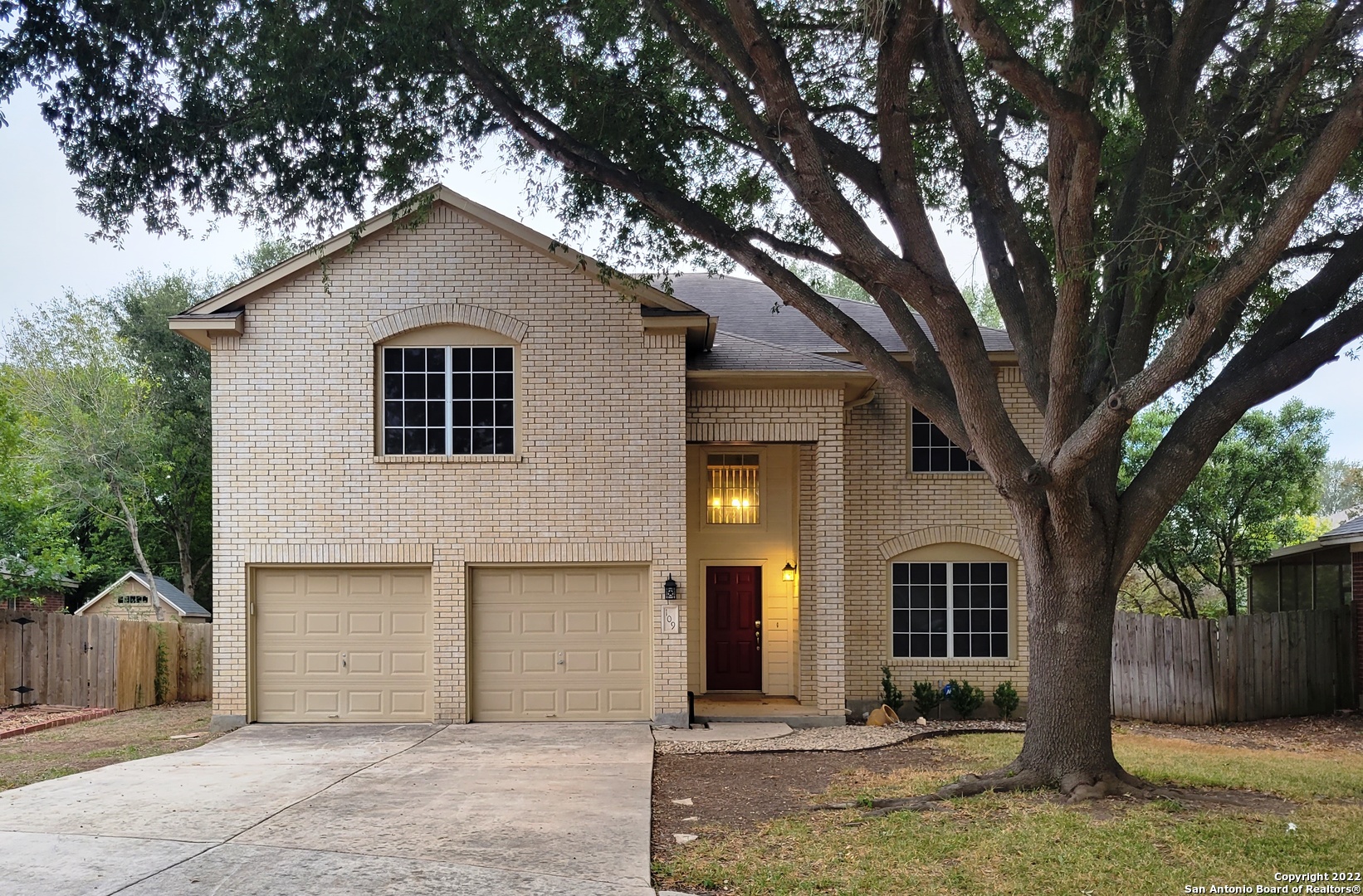 a house that has a tree in front of the house