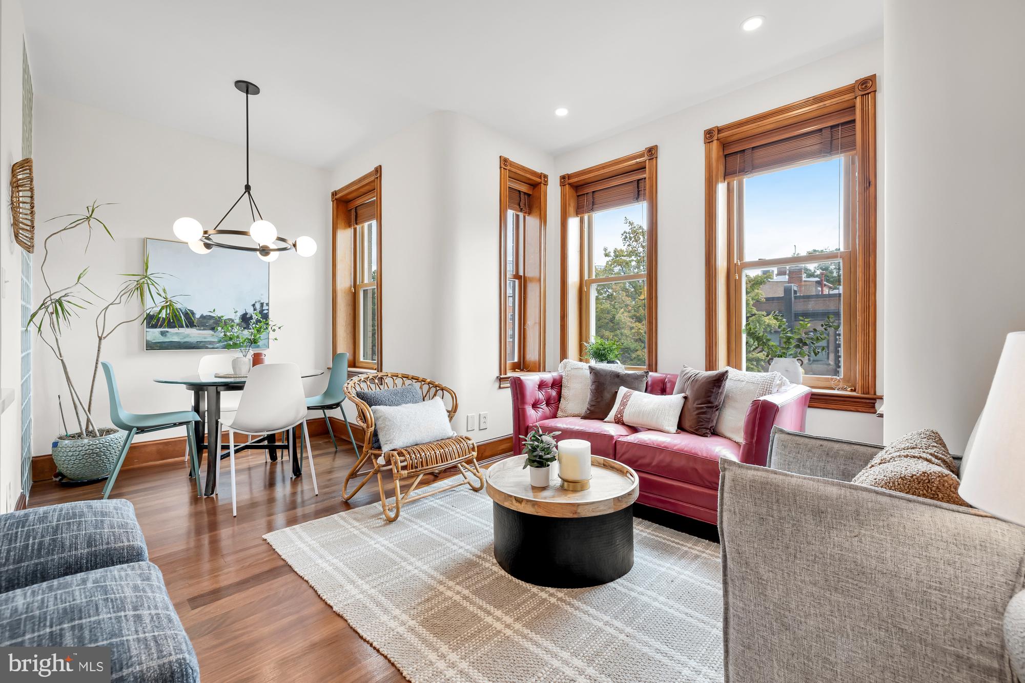 a living room with furniture a window and a dining table