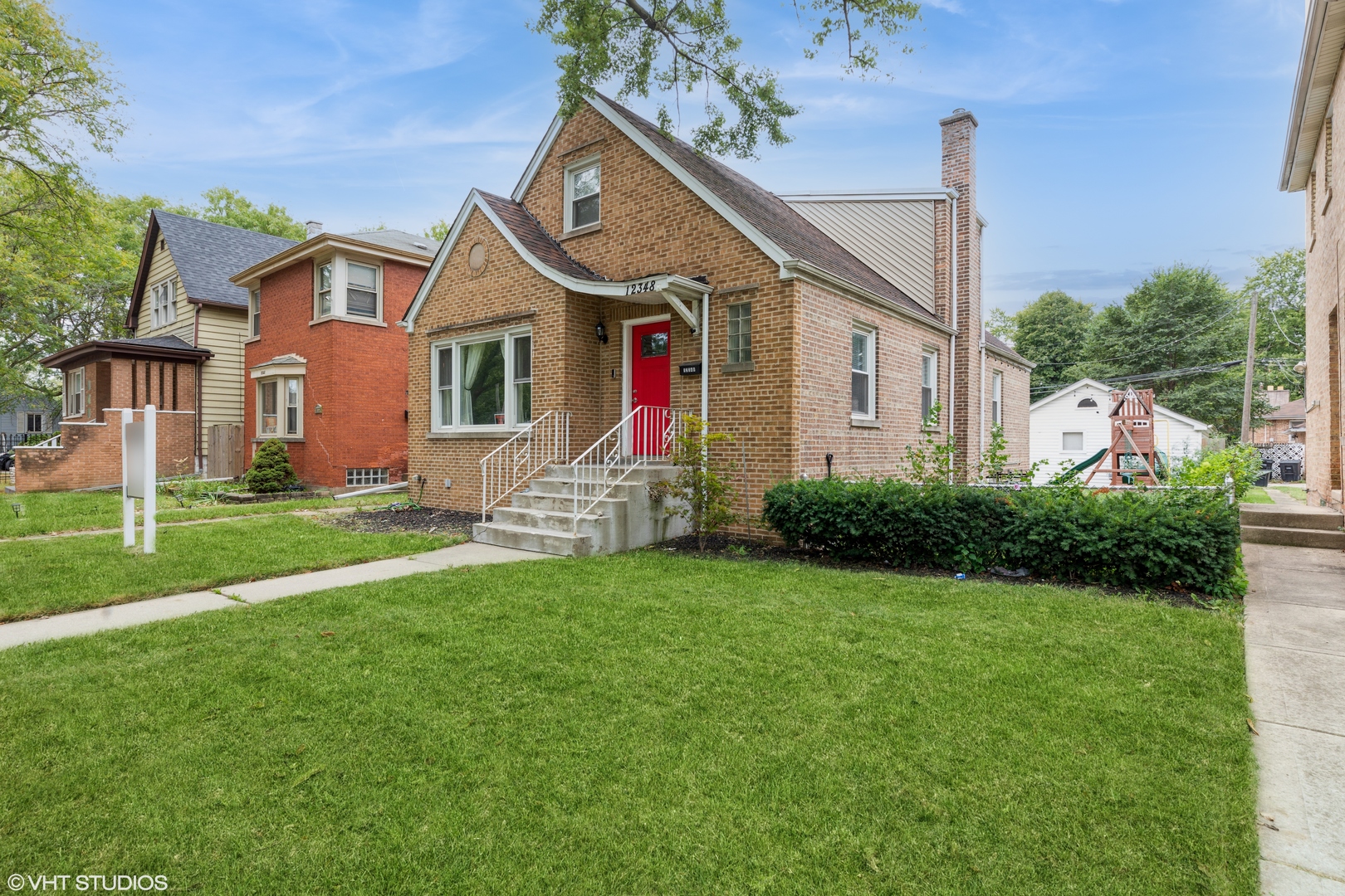 a front view of house with yard and green space