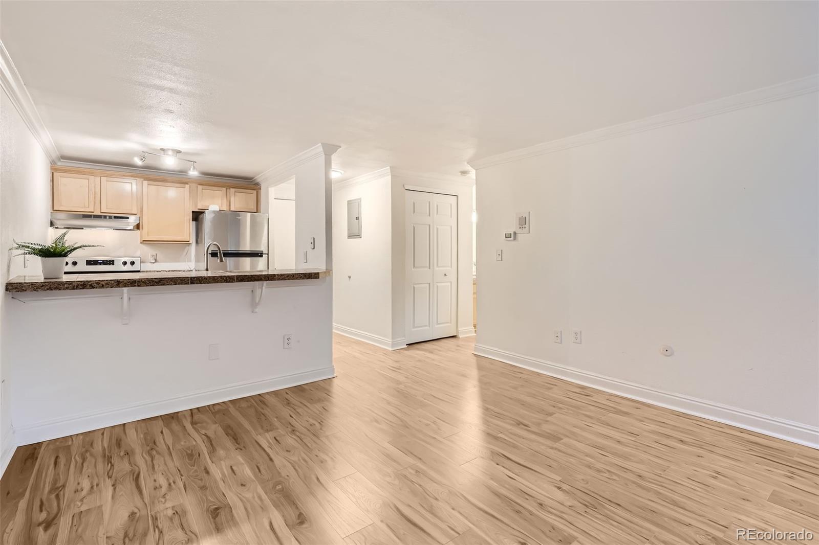 a view of a kitchen with granite countertop cabinets and wooden floor