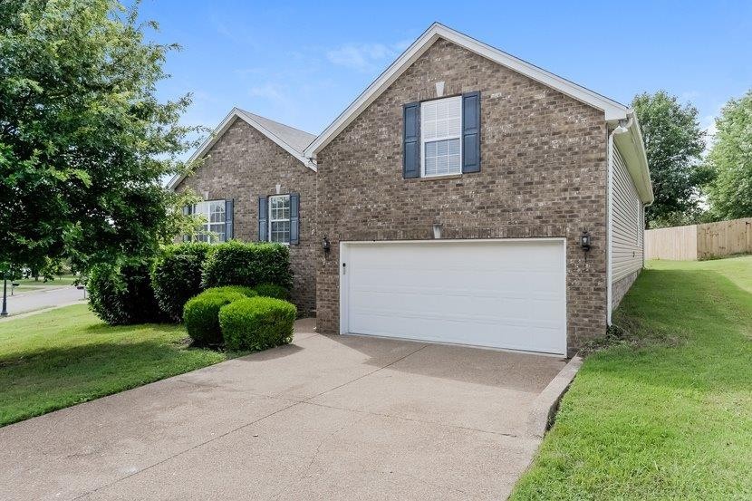 a front view of a house with yard and garage