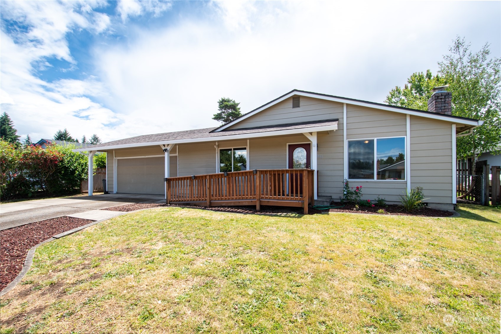 a view of a house with yard and sitting area