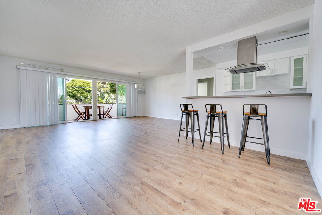 a dining room with furniture and a floor to ceiling window