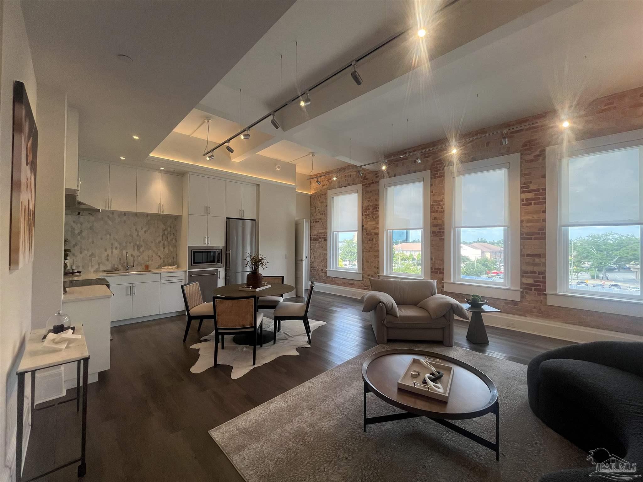 a living room with furniture window and wooden floor