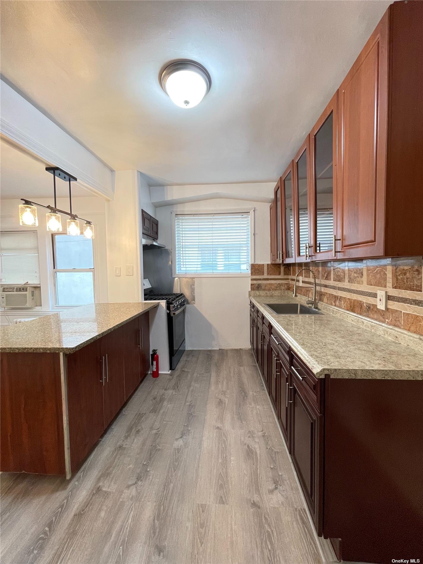 a kitchen with stainless steel appliances granite countertop a sink counter space and cabinets