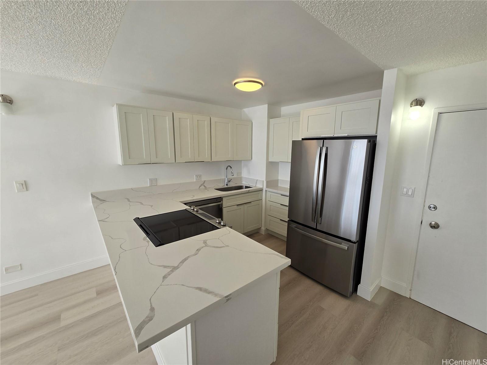 a kitchen with a refrigerator a sink and cabinets