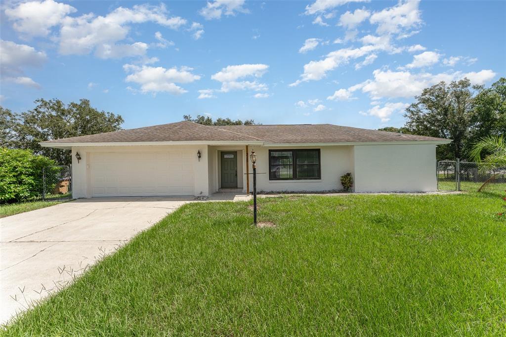 a house with green field in front of it