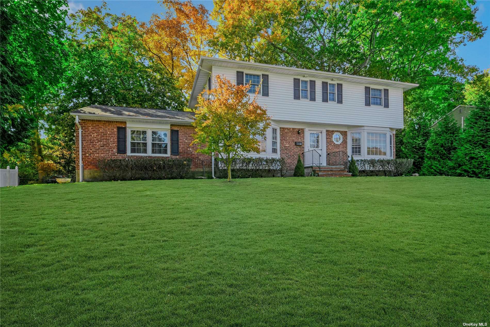 a front view of house with yard and green space