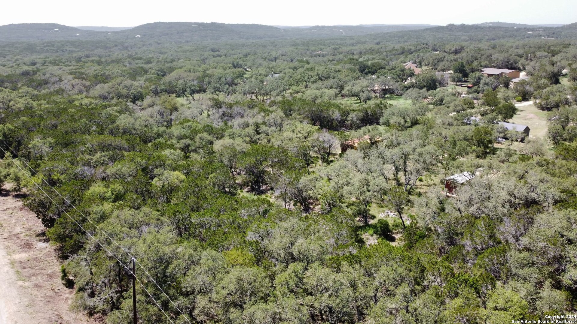 a view of a city with lush green forest