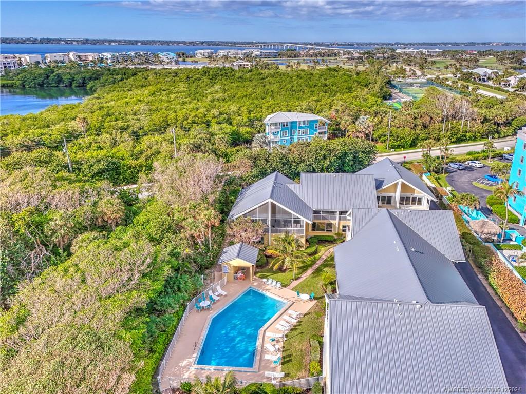 an aerial view of residential houses with outdoor space and swimming pool