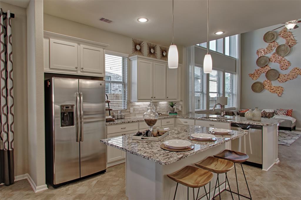 a kitchen with stainless steel appliances granite countertop a sink and cabinets