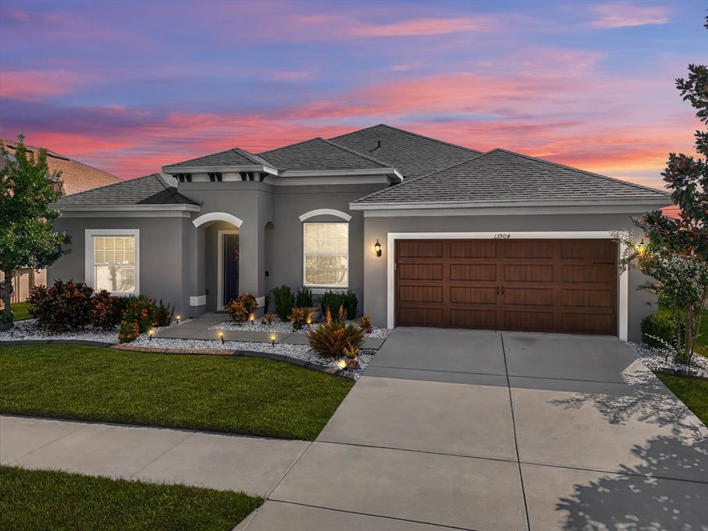 a front view of a house with a yard and garage