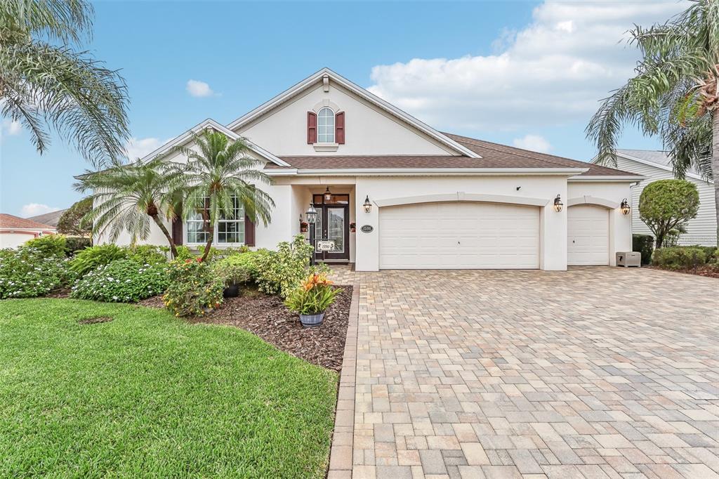 a front view of a house with a yard and garage