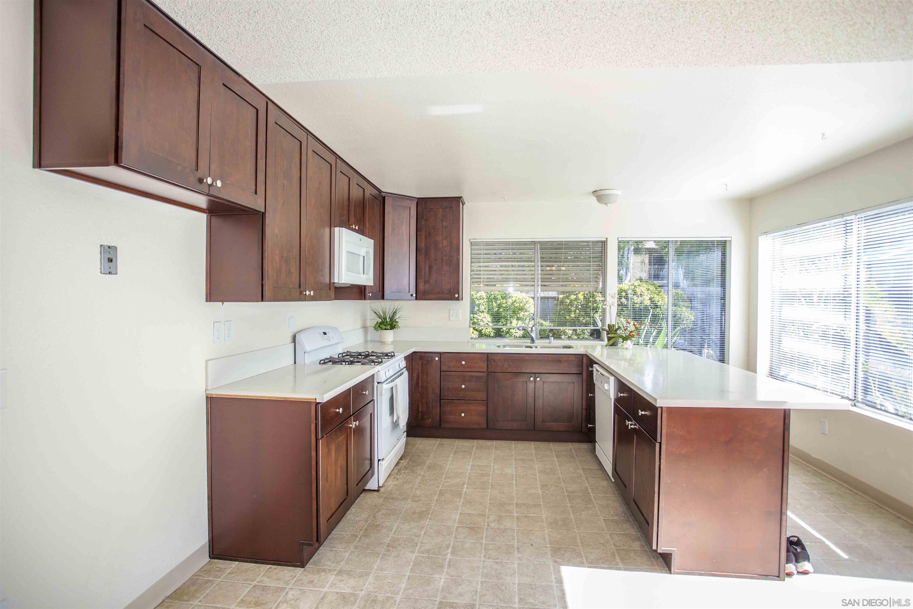 a kitchen with stainless steel appliances granite countertop a sink and cabinets